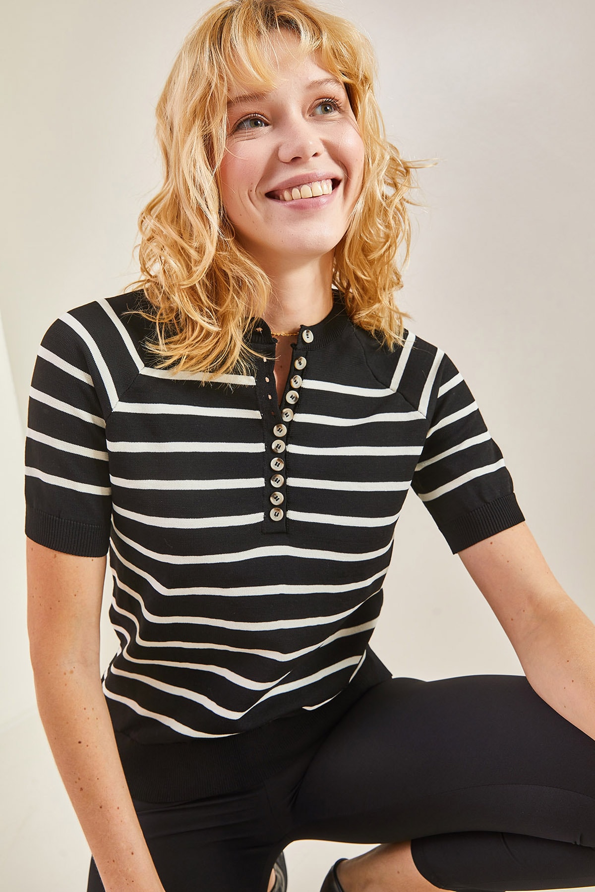 Bianco Lucci Women's Buttoned Elastic Knitwear Blouse at the sleeves and skirt.