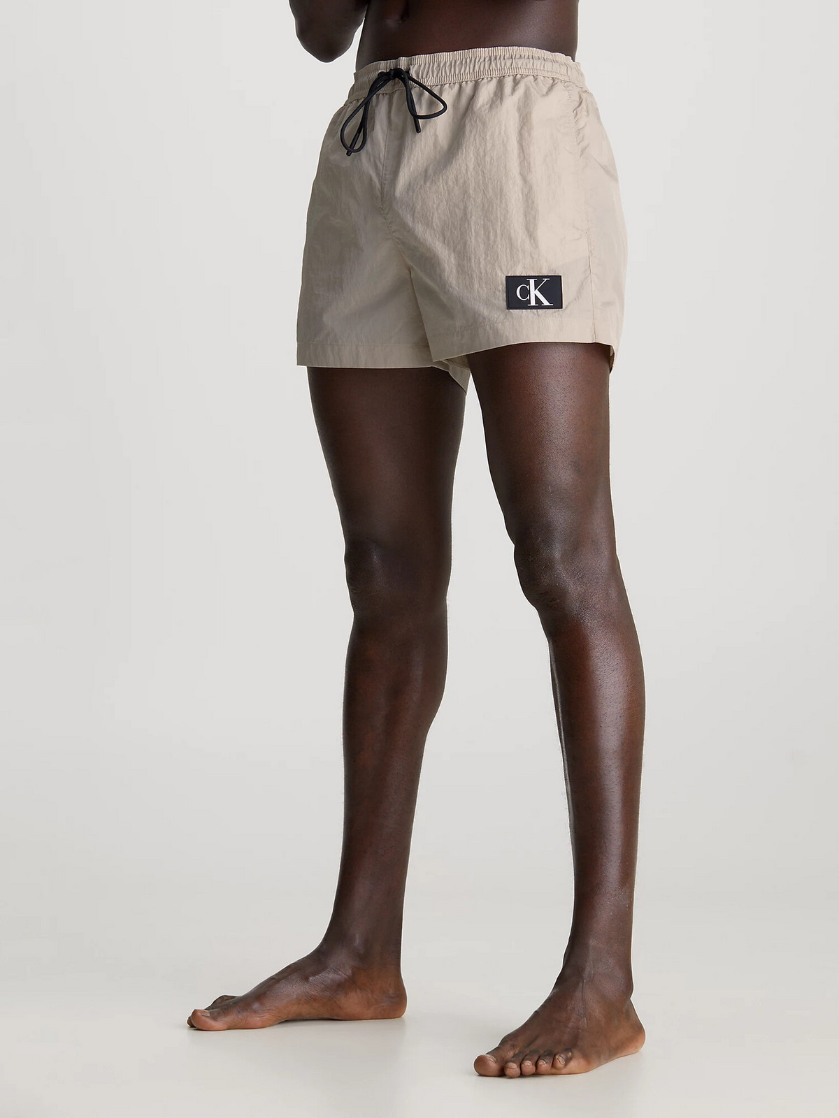 Pánske plavky KM0KM00979 PE0 beige - Calvin Klein L