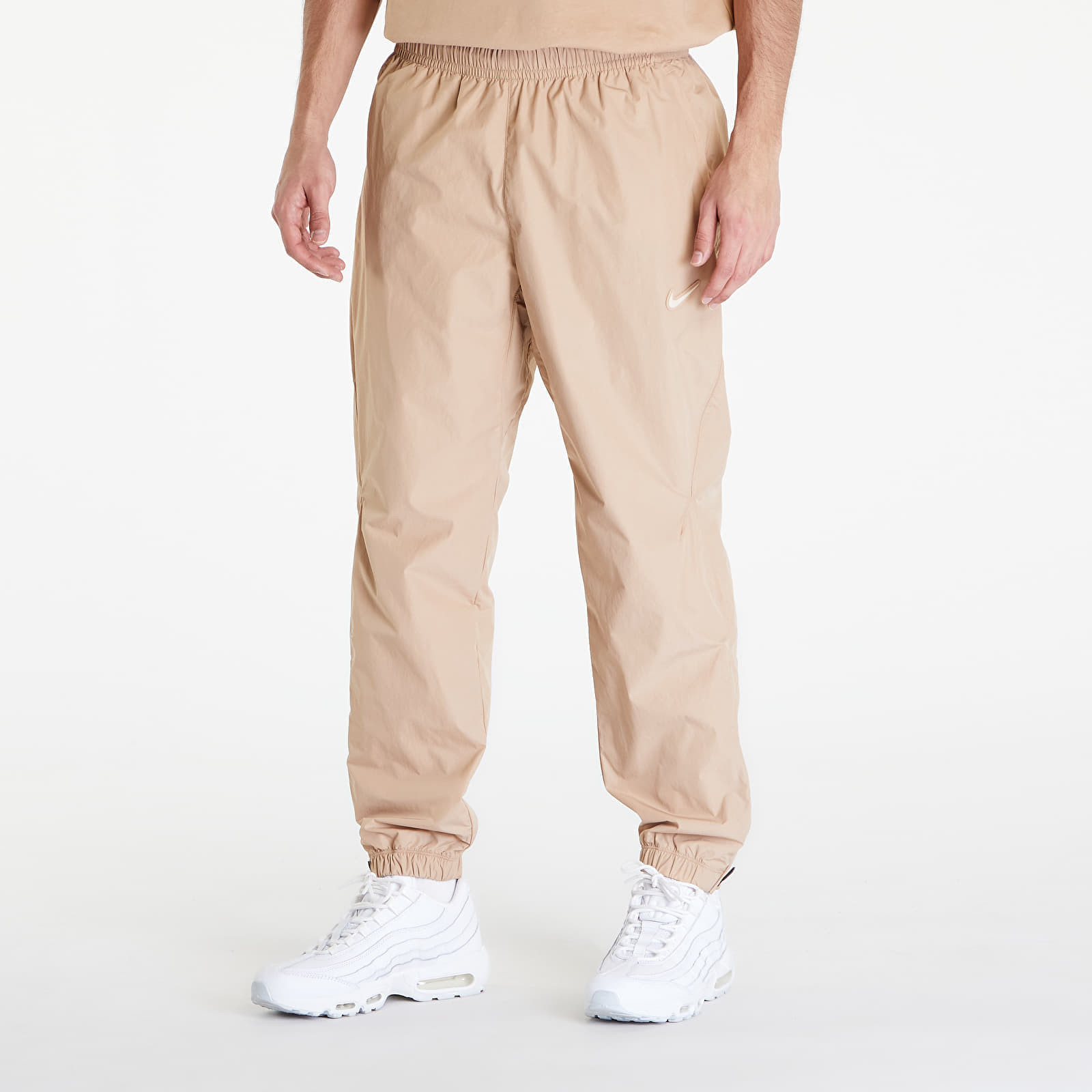Kalhoty Nike x NOCTA Woven Track Pants Hemp/ Sanddrift XS