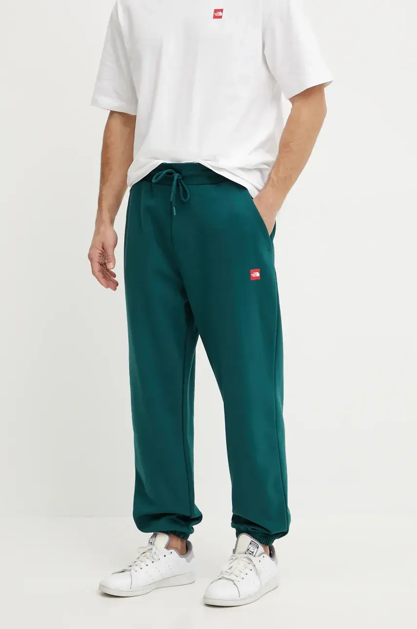 Bavlnené tepláky The North Face Axys pánske, zelená farba, jednofarebné, NF0A8C1U6GI1