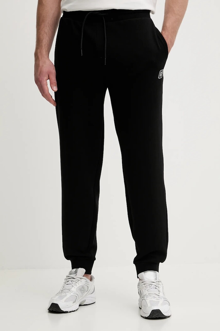 Bavlnené tepláky Guess MENTORE čierna farba, jednofarebné, Z5YB01 KCE91