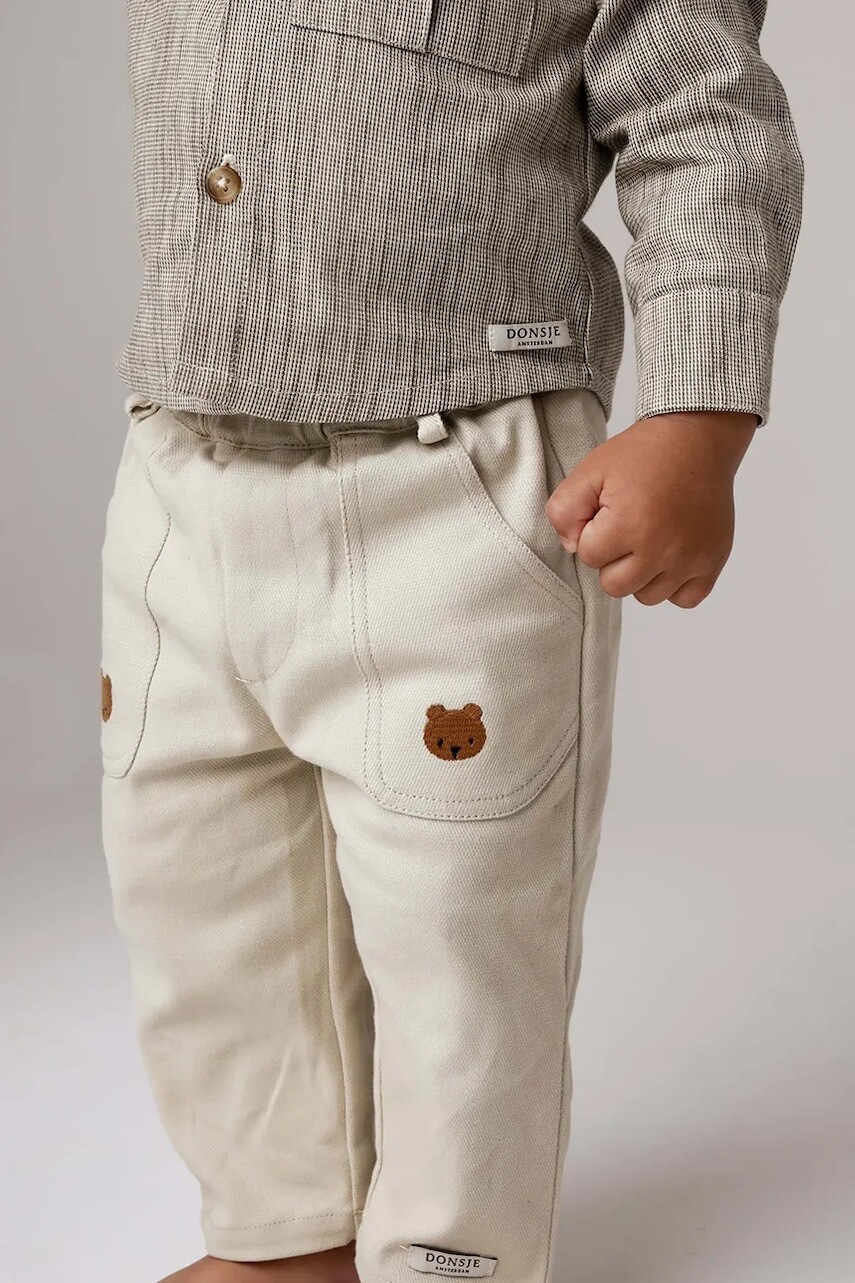 Detské bavlnené nohavičky Donsje Kassim Trousers Bear béžová farba, jednofarebné, 4096301