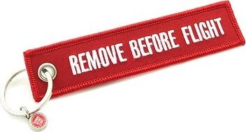 RBF Originals Kľúčenka Remove Before Flight, červená s bielym nápisom