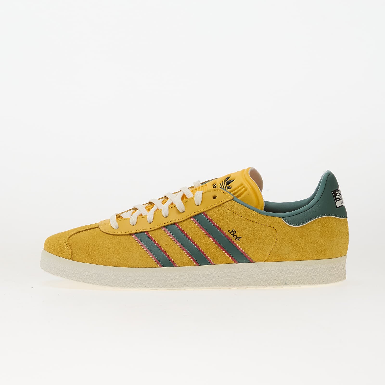 Tenisky adidas Gazelle Jamaica x Bob Marley Bold Gold/ None/ Pure Ruby EUR 41 1/3